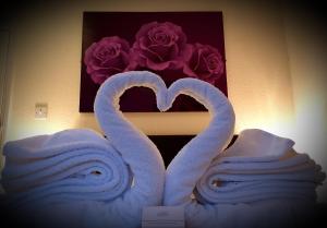 two white towels hanging on a wall next to each other at Medehamstede Hotel in Shanklin