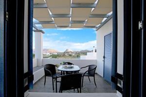 a balcony with a table and chairs and a view at Kallisti Studios & Apartments in Skiros