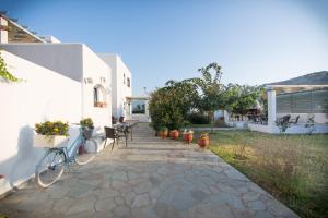 a patio with a bike parked next to a house at Kallisti Studios & Apartments in Skiros