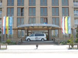 a white van parked in front of a building at Ribera Resort&SPA in Yevpatoriya
