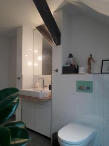 a white bathroom with a toilet and a sink at Fair Messe Rooftop Loft in Nürnberg in Nuremberg