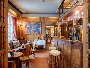 a restaurant with a bar with tables and chairs at Hotel Auberge D'Alle in Alle