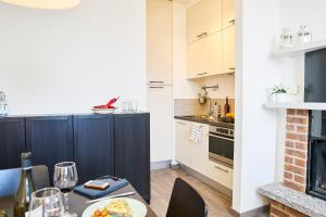 a kitchen with a dining table and a kitchen with a stove at Casa Francesca - Meravigliosa vista sul lago di Como in Menaggio