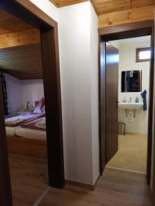 a door leading to a bedroom with a bed and a sink at Ferienwohnung Holiday Lienz in Lienz