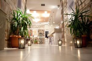 a hallway with potted plants and lights on the floor at Samothraki Village Hotel in Palaiopoli