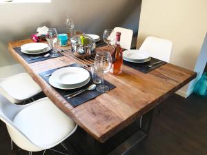 a wooden table with plates and wine glasses on it at Seeperle 4 in Meersburg