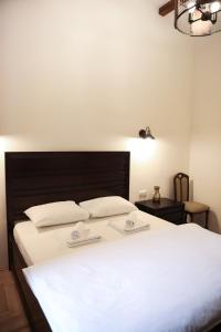 1 dormitorio con 1 cama con 2 almohadas blancas en Contessa Central Studio, en Cluj-Napoca