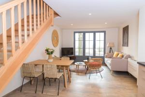 a living room with a table and chairs at Clos Castel Villas in Casteljaloux