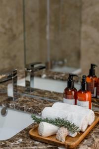 a bathroom counter with two bottles of soap and towels at Lemon Tree Home in Sesimbra
