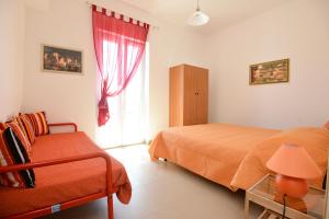 a bedroom with two beds and a window at Case Sangiorgio in Ginosa Marina