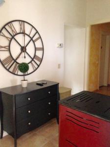 a kitchen with a clock on the wall and a dresser at Appartamento Antonio in Malo +1 photo