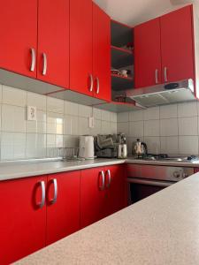 a kitchen with red cabinets and a counter top at Pansion Villa Bubalo in Mostar +52 photos