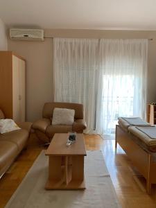 a living room with a couch and a coffee table at Pansion Villa Bubalo in Mostar