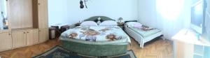 a bedroom with a bed with flowers on it at Apartments & Hostel Zdrava Hrana in Mostar