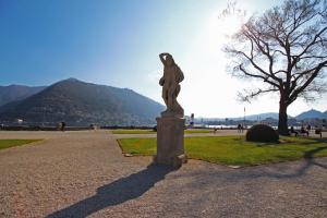 a statue of a woman on a pedestal in a park at Ancient Courtyard Bonanomi in Como Historic Centre in Como