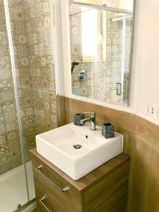 a bathroom with a white sink and a mirror at Casa Annamaria in Naples