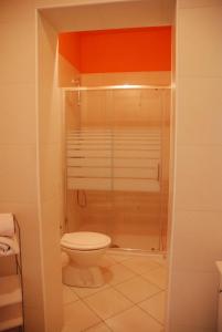 a bathroom with a toilet and a glass shower at Apartmani Radin in Poreč +16 photos
