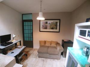 a living room with a couch and a desk at Casa Las Alamedas Guanajuato in Guanajuato