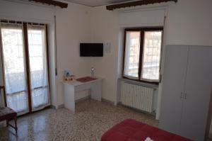 Cette chambre dispose d'un bureau, d'une télévision et de fenêtres. dans l'établissement B&B Olympo, à Salerne