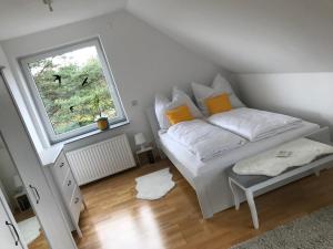 a white bed in a room with a window at Kleine Auszeit mit Aussicht Velbert Tönisheide in Velbert