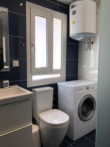 a bathroom with a washing machine and a washer at AGION APOSTOLON 4 in Corfu Town