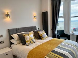 a bedroom with a bed with a view of the ocean at The Marlborough Sea View Holiday Apartments in Scarborough