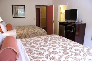 a hotel room with two beds and a flat screen tv at Harborview Inn & Suites-Convention Center-Airport-Gaslamp-Seaworld-Zoo-Balboa Park in San Diego