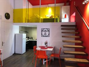 a kitchen and dining room with a table and a staircase at SOLOMOU APARTMENT in Corfu Town
