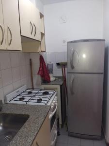 a kitchen with a stove and a refrigerator at Excepcional dpto frente a Plaza de la Intendencia in Córdoba