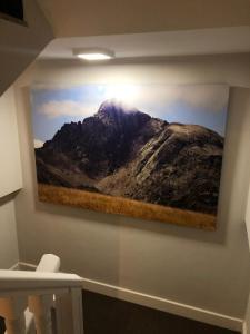 a picture of a mountain hanging on a wall at Hotel Valdecoro in Potes