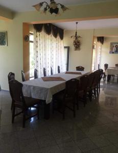 a dining room table and chairs in a room at Pensiunea '' LA PAPA'' in Huta Certeze