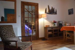 a living room with a chair and a desk at Lycia Rooms + in Inverness