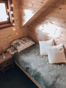 a bedroom with a bed in a wooden cabin at Holiday House Franc in Srednja Vas v Bohinju