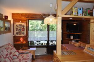 a living room with a couch and a large window at Triolet in La Chapelle-dʼAbondance