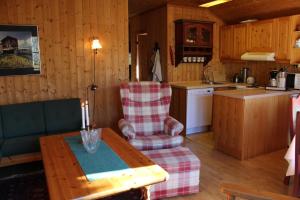a living room with a table and a kitchen at Ådnebu by Norgesbooking - cabin with 3 bedrooms in Geilo +9 photos