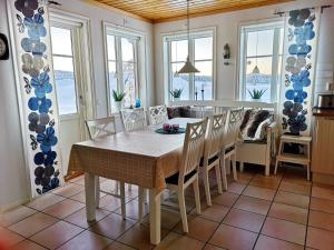 a dining room with a table and chairs at Skatauddens Lantgård in Älvsbyn