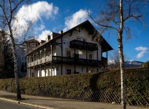 uma grande casa branca ao lado de uma rua em Das Nordberg Guesthouse em Garmisch-Partenkirchen