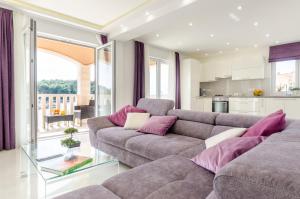 a living room with a couch and a glass table at KORČULA Antea Apartment in Prizba