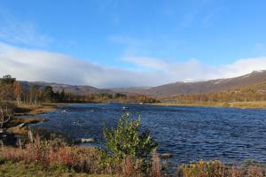 a view of a lake with mountains in the background at Ådnebu by Norgesbooking - cabin with 3 bedrooms in Geilo