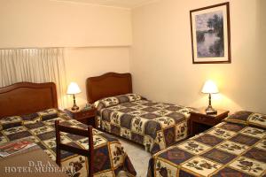 Un pat sau paturi într-o cameră la Hotel Mudejar