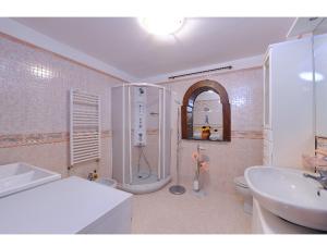 a bathroom with a sink and a toilet and a shower at Casa vacanze Civale con Jacuzzi e parcheggio in Ravello