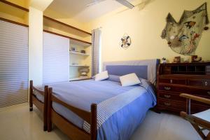 a bedroom with a blue bed and a dresser at VILLA LAURA MARIE in Porticello
