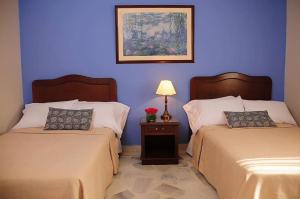 Un pat sau paturi într-o cameră la Hotel Mudejar