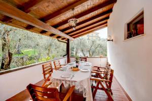a dining room with a table and chairs on a balcony at My Malcesine Family Home XL in Malcesine