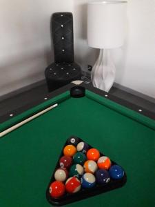 a pool table with a cue and some balls at Domaine de cyrcé in La Celle +13 photos
