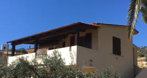 a white house with a roof at Villaluciana Solanas in Solanas