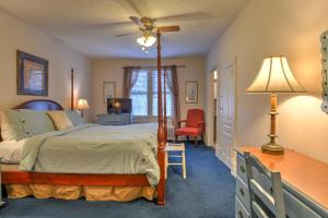 a bedroom with a bed and a desk and a chair at 1898 Waverly Inn in Hendersonville