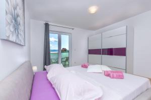 a bedroom with two beds and a large window at Apartment Ivano in Dugi Rat
