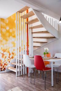 a dining room with a table and chairs and stairs at Piaskowa Polana in Dębki