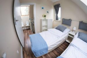 ein kleines Schlafzimmer mit 2 Betten und einem Spiegel in der Unterkunft Piaskowa Polana in Dębki